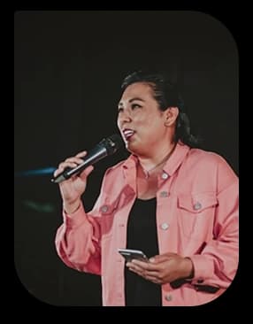 Female speaker delivering a talk with a microphone